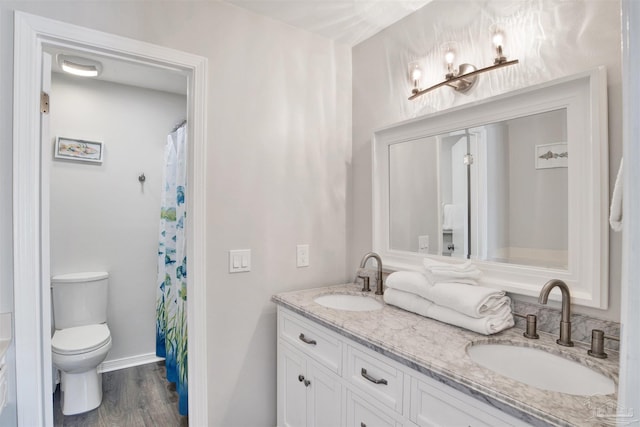 bathroom featuring hardwood / wood-style floors, vanity, and toilet