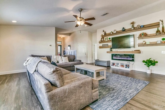 living room featuring dark hardwood / wood-style flooring and ceiling fan