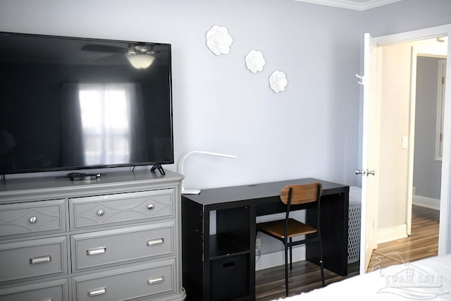 bedroom featuring baseboards and wood finished floors