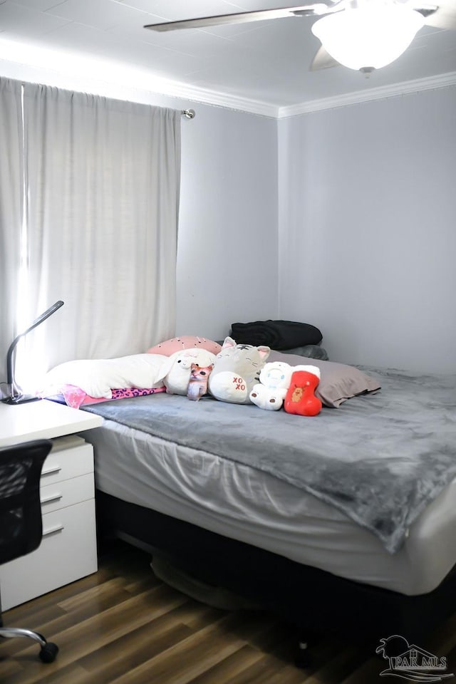 bedroom with ceiling fan, dark wood-style flooring, and ornamental molding