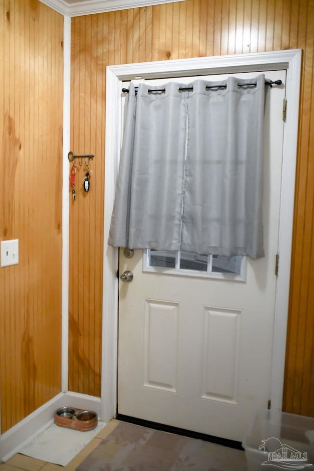 doorway with wood walls