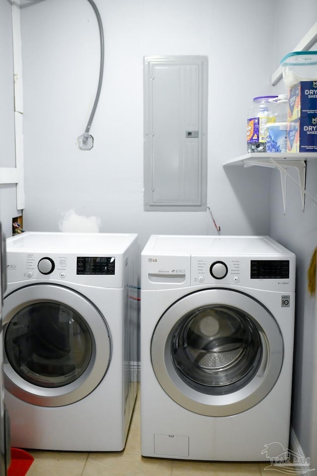 clothes washing area featuring electric panel, laundry area, independent washer and dryer, and light tile patterned floors