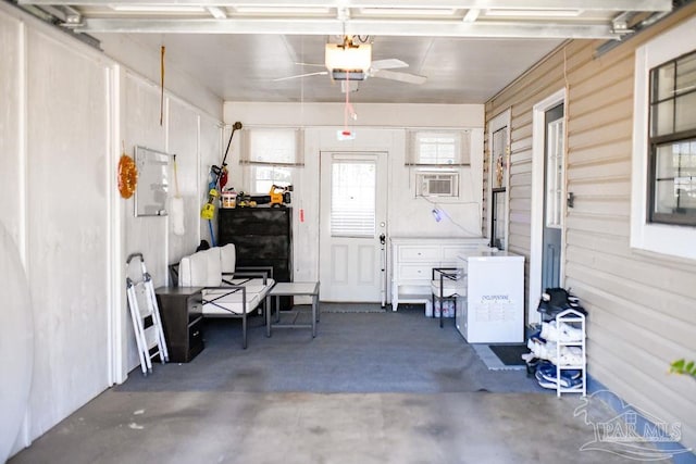 garage featuring cooling unit and a garage door opener