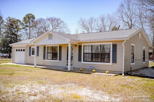 ranch-style house featuring board and batten siding, an attached garage, a front lawn, and roof with shingles