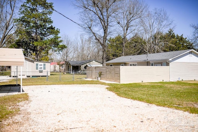 view of yard featuring a fenced front yard and a gate