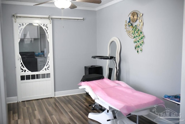 interior space featuring ceiling fan, wood finished floors, baseboards, and ornamental molding