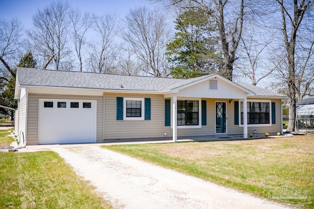 ranch-style house featuring a front lawn, a garage, and driveway