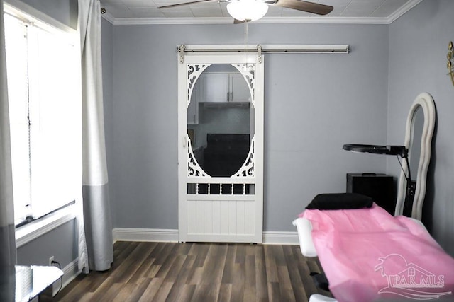 interior space with a ceiling fan, dark wood-style floors, baseboards, and ornamental molding