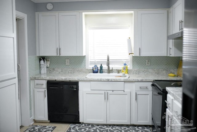 kitchen with a sink, decorative backsplash, black appliances, white cabinets, and under cabinet range hood