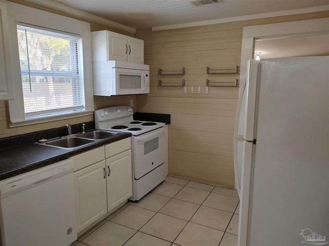 kitchen with sink, white appliances, white cabinets, and light tile patterned flooring