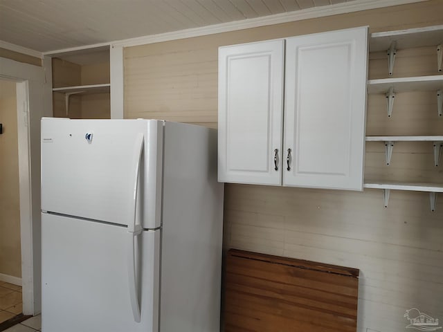 kitchen featuring white refrigerator and white cabinets