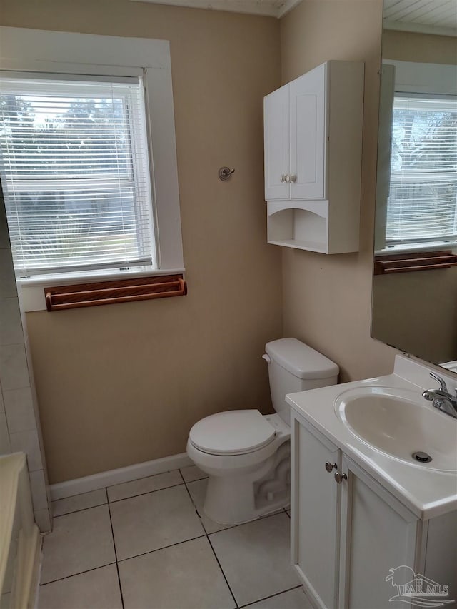 bathroom featuring vanity, tile patterned floors, and toilet