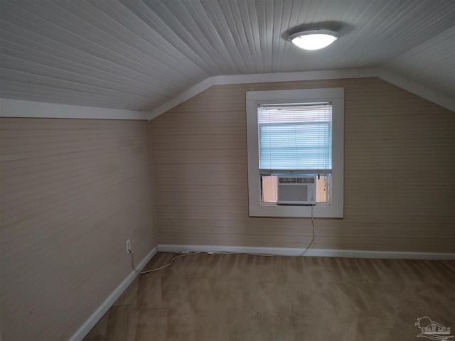 additional living space featuring cooling unit, vaulted ceiling, and carpet flooring