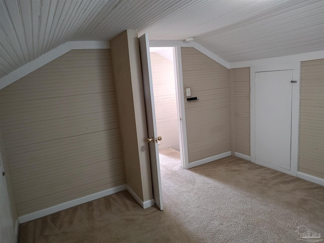 bonus room with vaulted ceiling and carpet flooring