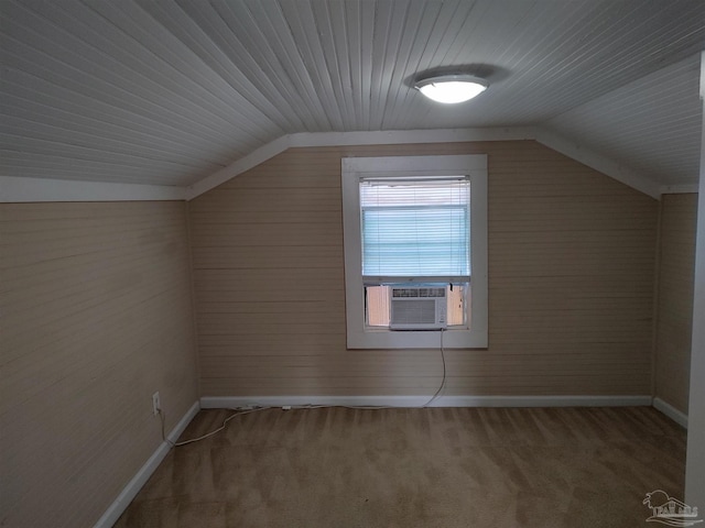 additional living space with cooling unit, lofted ceiling, and carpet floors