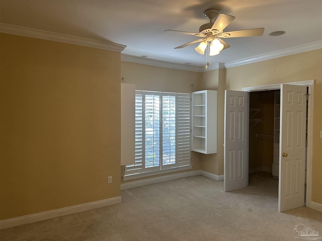 unfurnished bedroom featuring carpet, baseboards, and crown molding