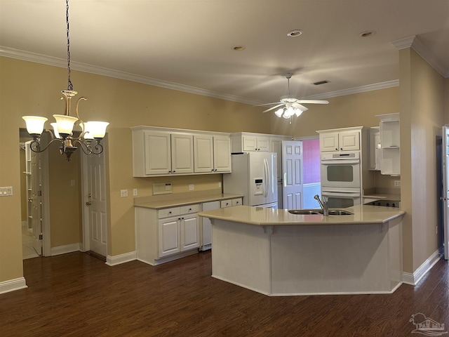 kitchen with white cabinets, white appliances, light countertops, and a sink