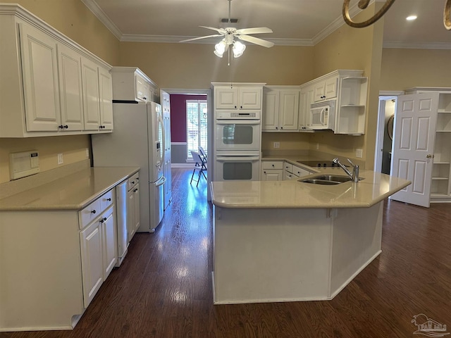 kitchen featuring ornamental molding, white appliances, a sink, and dark wood-style flooring