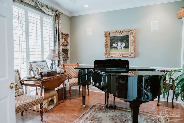 living area with ornamental molding, wood finished floors, and recessed lighting