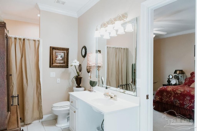 bathroom featuring vanity, ornamental molding, toilet, and tile patterned floors