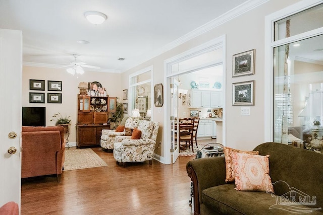 living room featuring ornamental molding, ceiling fan, and dark hardwood / wood-style flooring