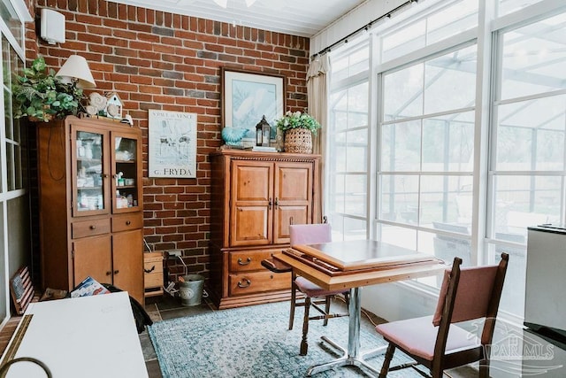 home office featuring brick wall