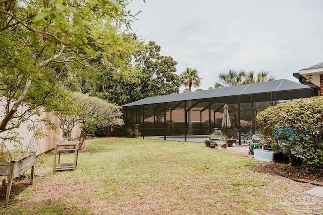 view of yard with a swimming pool and a lanai