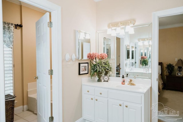 full bath with baseboards, vanity, and tile patterned floors