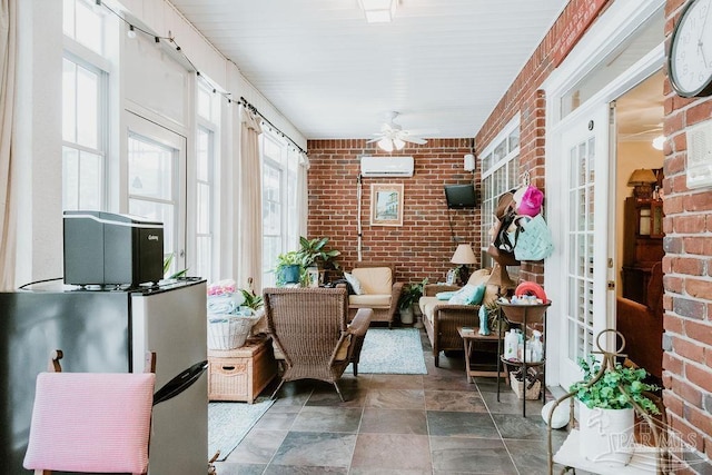 sunroom / solarium featuring a wall unit AC and a ceiling fan