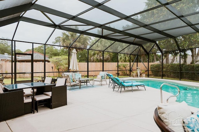 view of swimming pool with a patio, a fenced backyard, glass enclosure, and a fenced in pool