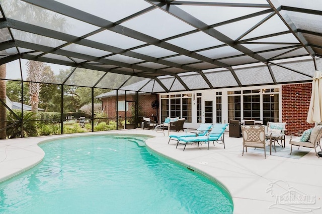 outdoor pool featuring a lanai, a patio area, and an outdoor hangout area