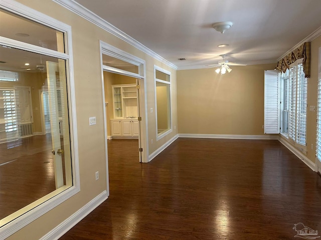 empty room featuring ornamental molding, ceiling fan, and dark hardwood / wood-style flooring