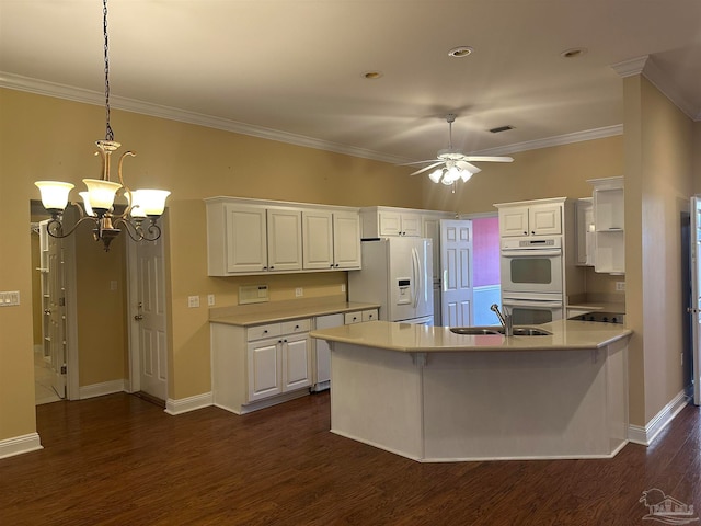 kitchen with dark hardwood / wood-style floors, white cabinets, sink, and white appliances