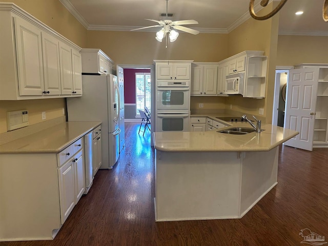 kitchen featuring kitchen peninsula, ornamental molding, white cabinetry, white appliances, and dark hardwood / wood-style flooring