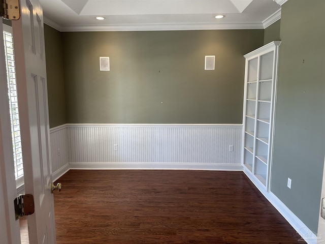 spare room with ornamental molding, recessed lighting, a wainscoted wall, and dark wood finished floors