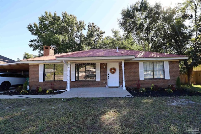 single story home with a front lawn and a carport