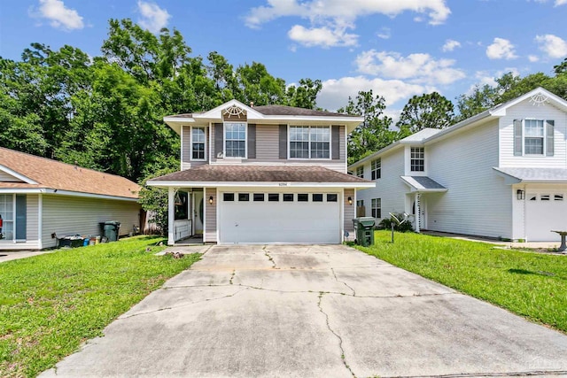 view of property featuring a garage and a front yard