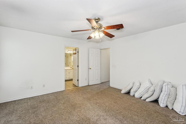 unfurnished bedroom featuring ensuite bathroom, ceiling fan, and light colored carpet