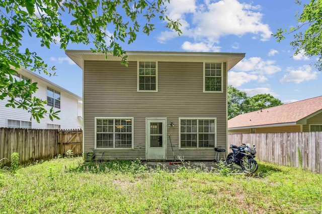 back of property featuring a lawn