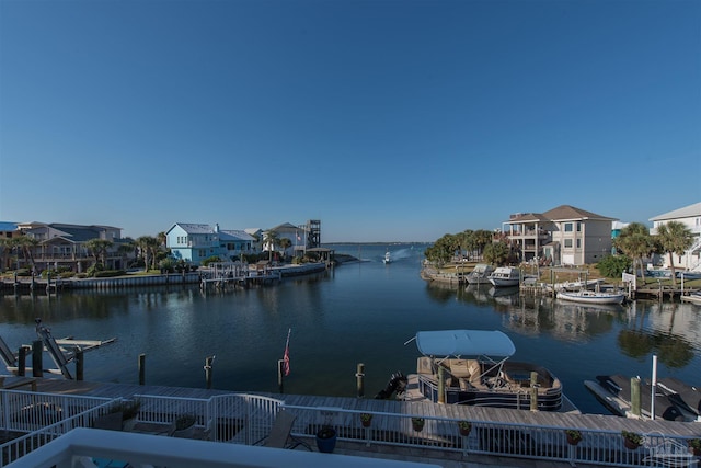 water view featuring a dock, boat lift, and a residential view