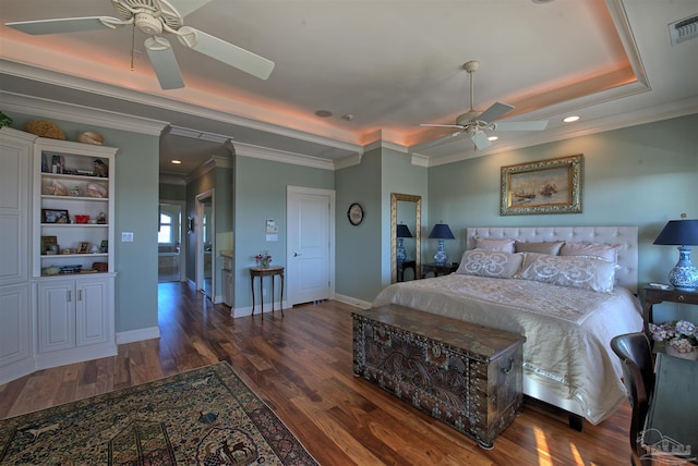 bedroom with crown molding, dark wood-style flooring, a raised ceiling, and baseboards