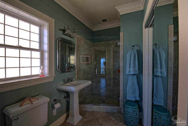 bathroom with ornamental molding, a stall shower, toilet, and tile patterned floors