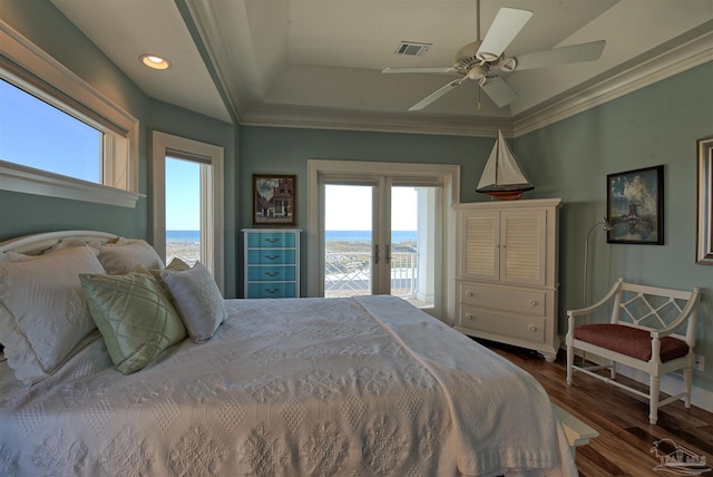 bedroom featuring dark wood-type flooring, a water view, access to outside, crown molding, and french doors