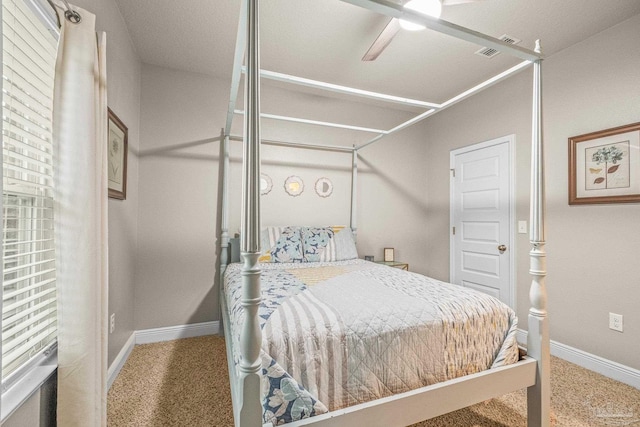 bedroom with a ceiling fan, carpet flooring, and baseboards