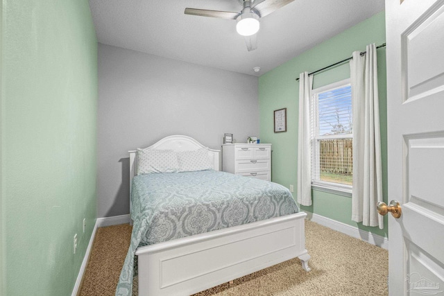 bedroom with carpet floors, ceiling fan, and baseboards