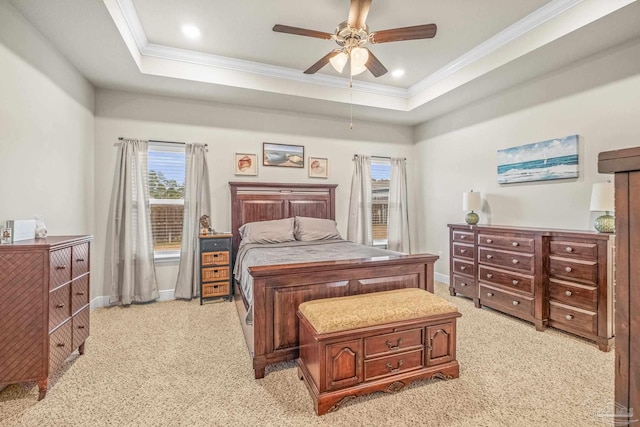 bedroom with baseboards, recessed lighting, a raised ceiling, and crown molding