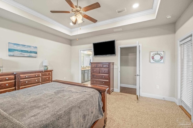 carpeted bedroom featuring ornamental molding, a raised ceiling, visible vents, and baseboards