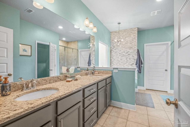 full bathroom featuring a stall shower, a sink, visible vents, and tile patterned floors