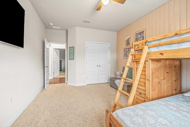 bedroom featuring visible vents, a ceiling fan, carpet flooring, a textured ceiling, and baseboards