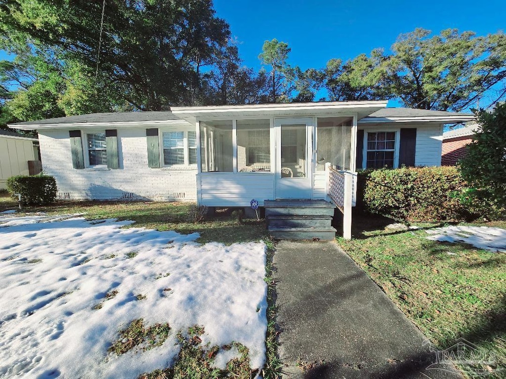 view of front of home featuring a sunroom